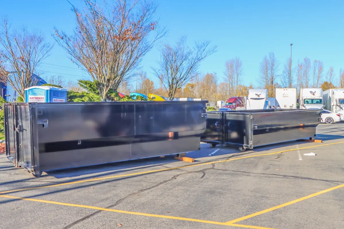 Professional dumpster rental service with roll-off container on residential driveway in Sedalia